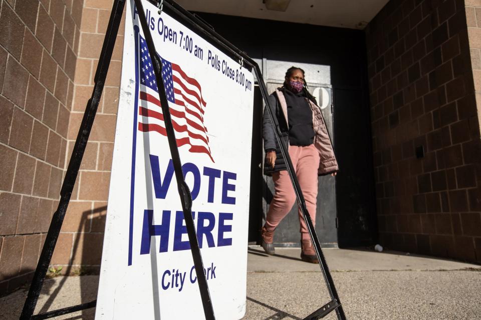 People leave after casting their ballots at Carstens Elementary-Middle School in Detroit on Tuesday, Nov. 2, 2021.