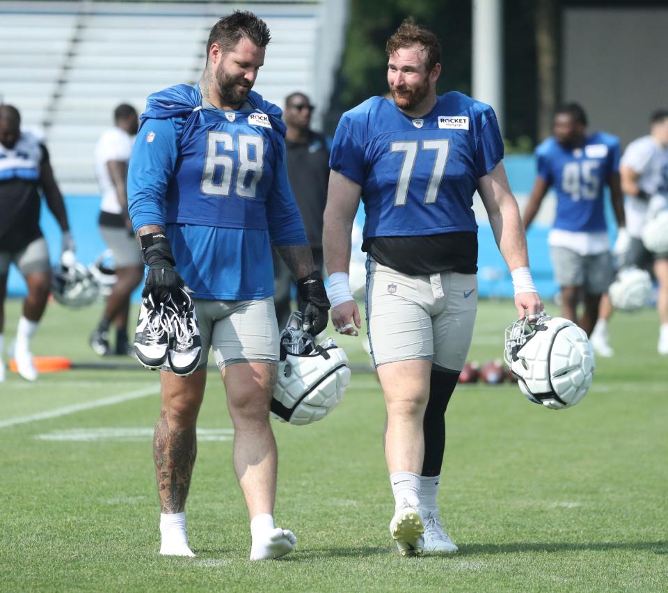 Lions offensive tackle <a class="link " href="https://sports.yahoo.com/nfl/players/29250" data-i13n="sec:content-canvas;subsec:anchor_text;elm:context_link" data-ylk="slk:Taylor Decker;sec:content-canvas;subsec:anchor_text;elm:context_link;itc:0">Taylor Decker</a>, left, and center <a class="link " href="https://sports.yahoo.com/nfl/players/30990" data-i13n="sec:content-canvas;subsec:anchor_text;elm:context_link" data-ylk="slk:Frank Ragnow;sec:content-canvas;subsec:anchor_text;elm:context_link;itc:0">Frank Ragnow</a> walk off the field after training camp on Wednesday, July 26, 2023, in Allen Park.