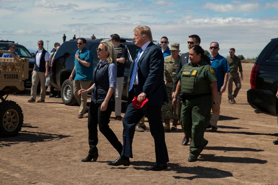 President Donald Trump walks with Homeland Security