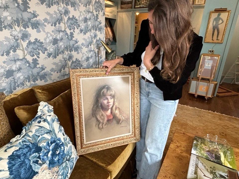 Oakstreet Shoppe owner Rebecca Gibbs shows off this one of a kind art piece displayed in the store April 19. The owners personally source pieces from local artists to sell in the store.