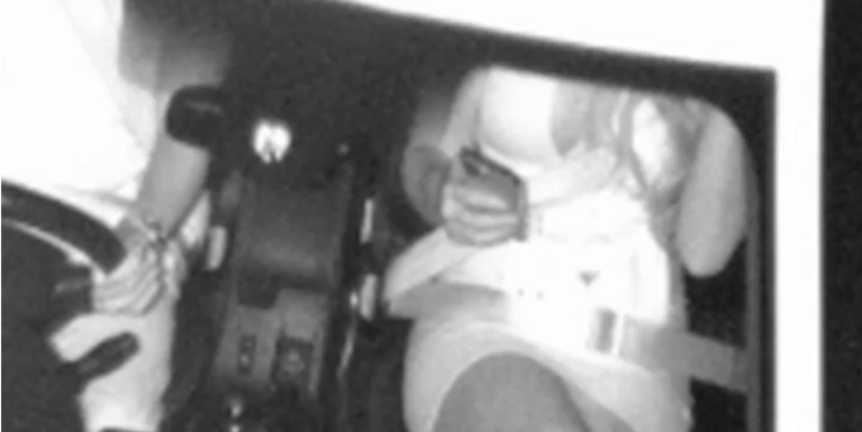 The roadside camera photo of Mike Gambaro's date wearing her seatbelt in the passenger's seat. 