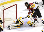 New Jersey Devils left wing Miles Wood (44) scores a goal past Pittsburgh Penguins goaltender Casey DeSmith (1) as Wood is checked by Penguins defenseman Kris Letang (58) during the first period of an NHL hockey game Friday, April 9, 2021, in Newark, N.J. (AP Photo/Bill Kostroun)