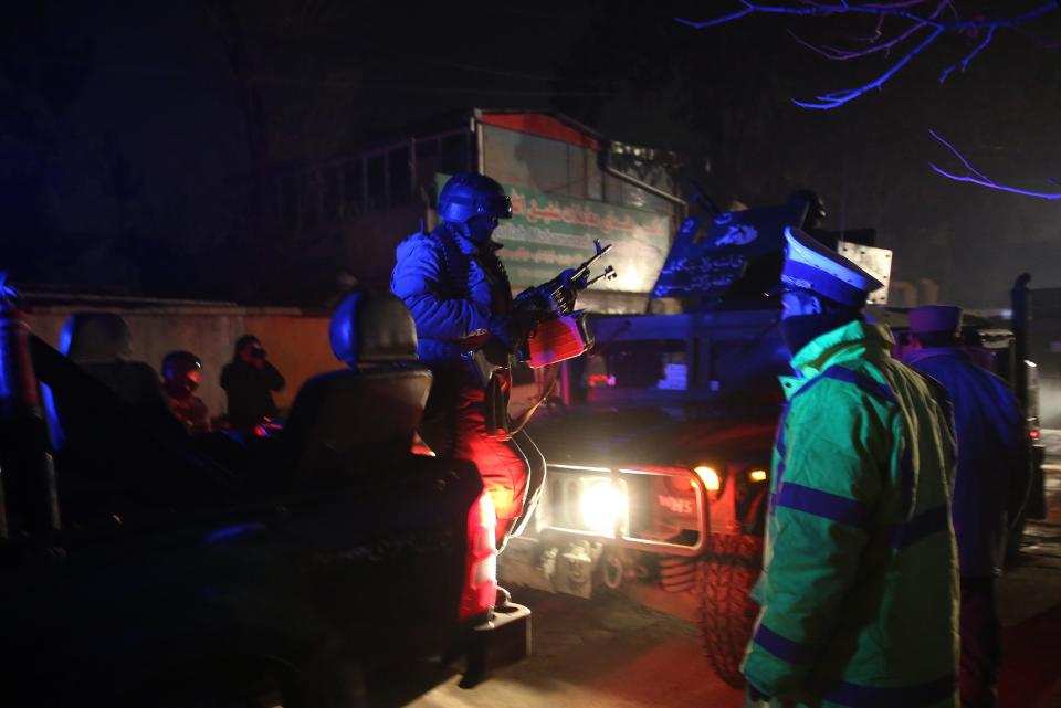 Afghan security forces arrive at the site of a suicide attack in Kabul, Afghanistan, Friday, Jan. 17, 2014. Afghan police say a suicide bomber has attacked a restaurant in central Kabul that is popular with officials, foreigners and business people. There were reports of casualties. (AP Photo/Massoud Hossaini)