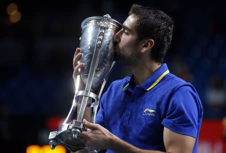 Croatia's Marin Cilic kisses his trophy after defeating Spain's Roberto Bautista-Agut in the men's singles final at the Kremlin cup tennis tournament in Moscow October 19, 2014. REUTERS/Grigory Dukor