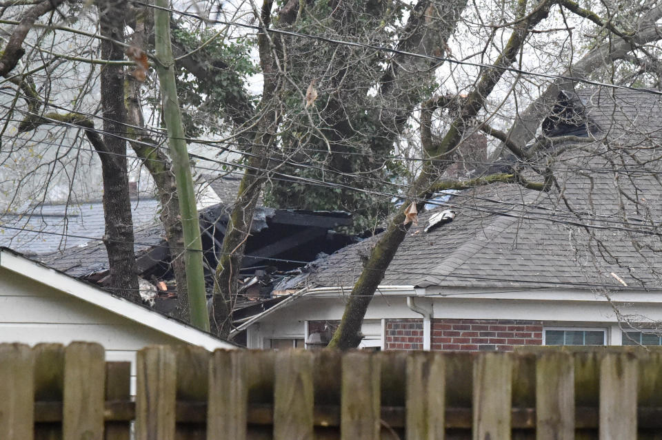 Damage is visible following a small plane crash during dense fog in a residential neighborhood on Wednesday, Jan. 13, 2021, in Columbia, S.C. Officials say the woman home at the time safely escaped after the crash caused a fire that damaged her roof and house. (AP Photo/Meg Kinnard)