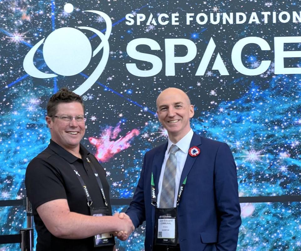 Eric Blackhurst, left, vice president of business development at PlaneWave Instruments, shakes hands with Jean-Edouard Communal, right, the CEO and founder of Miratlas, a France-based innovative company specializing in atmospheric monitoring technology during the 39th annual Space Symposium in Colorado Springs, Colorado.