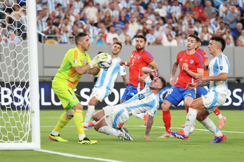 Alexis Mac Allister reacts after missing a shot on goal, saved by Chile's goalkeeper #01 Claudio Bravo, during the Conmebol 2024 Copa America tournament group A football match between Chile and Argentina at MetLife Stadium in East Rutherford, New Jersey on June 25, 2024.