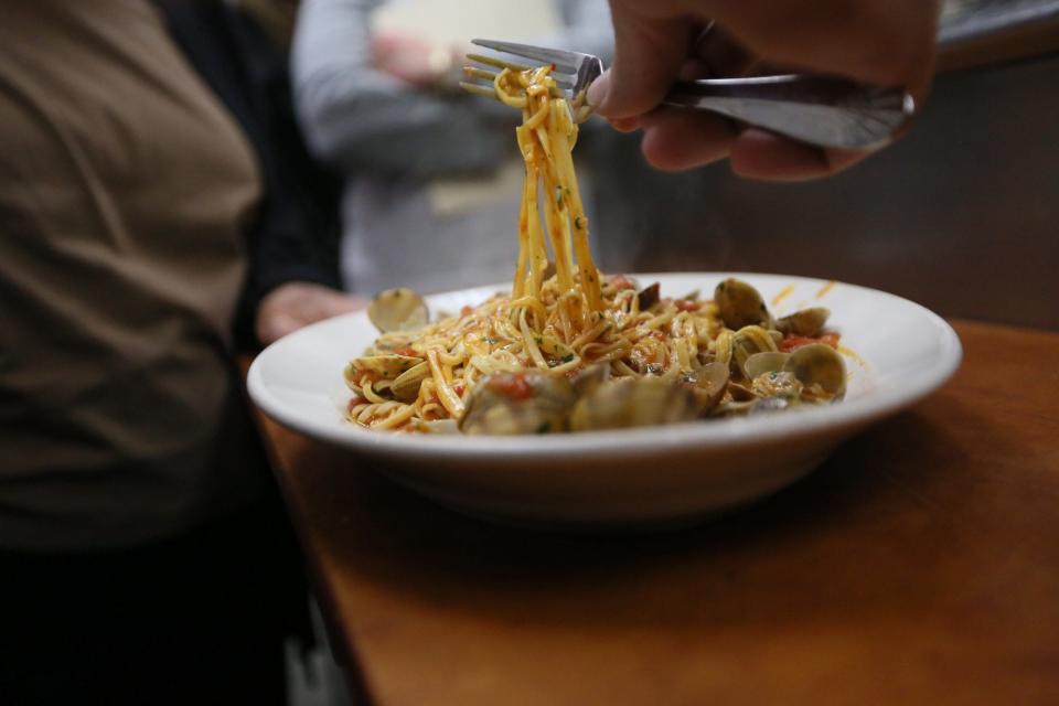 Chef Luciano DelSignore plates pasta with clam sauce at Bacco Ristorante in Southfield, Michigan, on Saturday, Nov. 23, 2013.