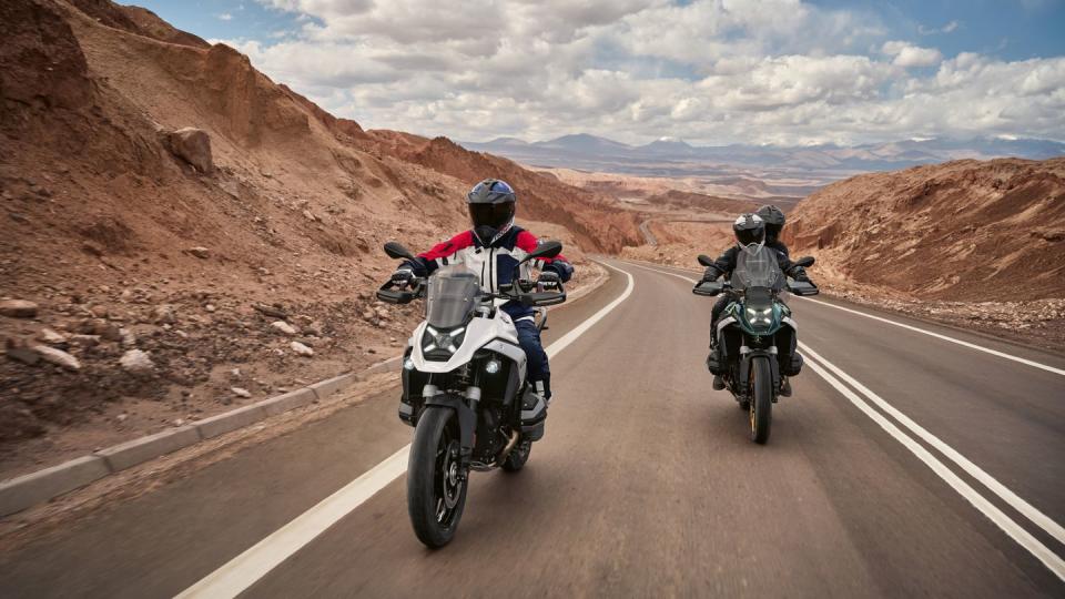 two 2024 bmw r 1300 gs riding on desert road