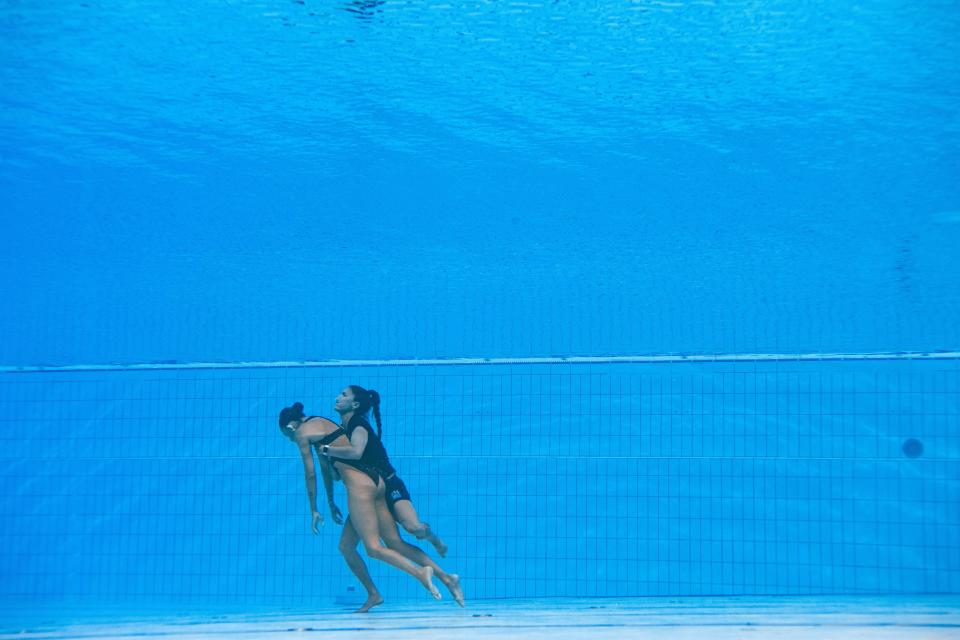 A member of Team USA (R) recovers USA's Anita Alvarez (L), from the bottom of the pool during an incendent in the women's solo free artistic swimming finals, during the Budapest 2022 World Aquatics Championships at the Alfred Hajos Swimming Complex in Budapest on June 22, 2022.