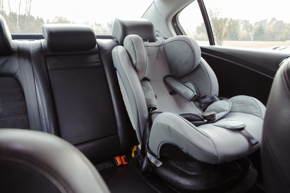 A car seat pictured in a vehicle.