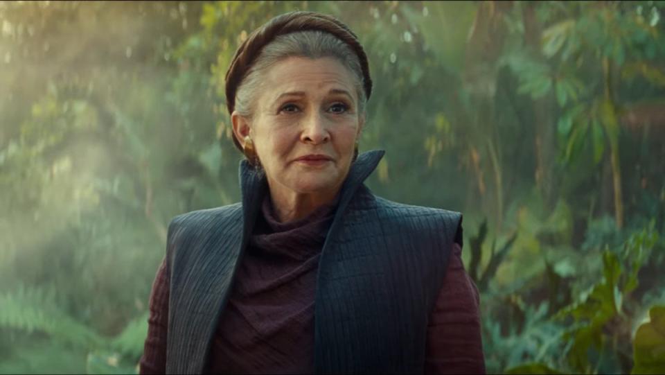 General Leia Organa stands in front of foliage in The Rise of Skywalker