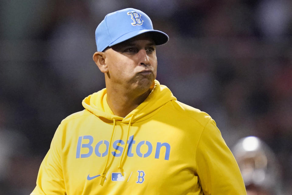 Boston Red Sox manager Alex Cora heads back to the dugout after checking on the condition of Jose Iglesias, who was hit by a pitch, during the sixth inning of a baseball game against the New York Mets at Fenway Park, Tuesday, Sept. 21, 2021, in Boston. (AP Photo/Charles Krupa)