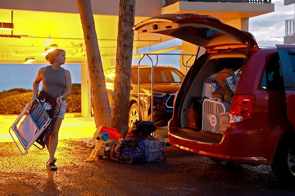 TAMPA, FLORIDA - AUGUST 28: Brooke Painter loads personal items into a van as she and her family evacuate their vacation rental ahead of the possible arrival of Hurricane Idalia on August 28, 2023 in Tampa, Florida. Tropical Storm Idalia is nearing hurricane strength and is forecast to become a hurricane as it tracks toward the Gulf Coast of Florida. (Photo by Joe Raedle/Getty Images)