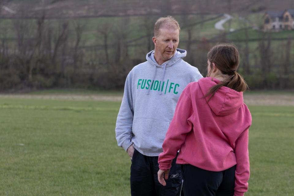 Mike Quinn, injury management coach of select girls soccer squad Fusion FC Fury, talks with a player during team practice on Tuesday, March 28, 2023.