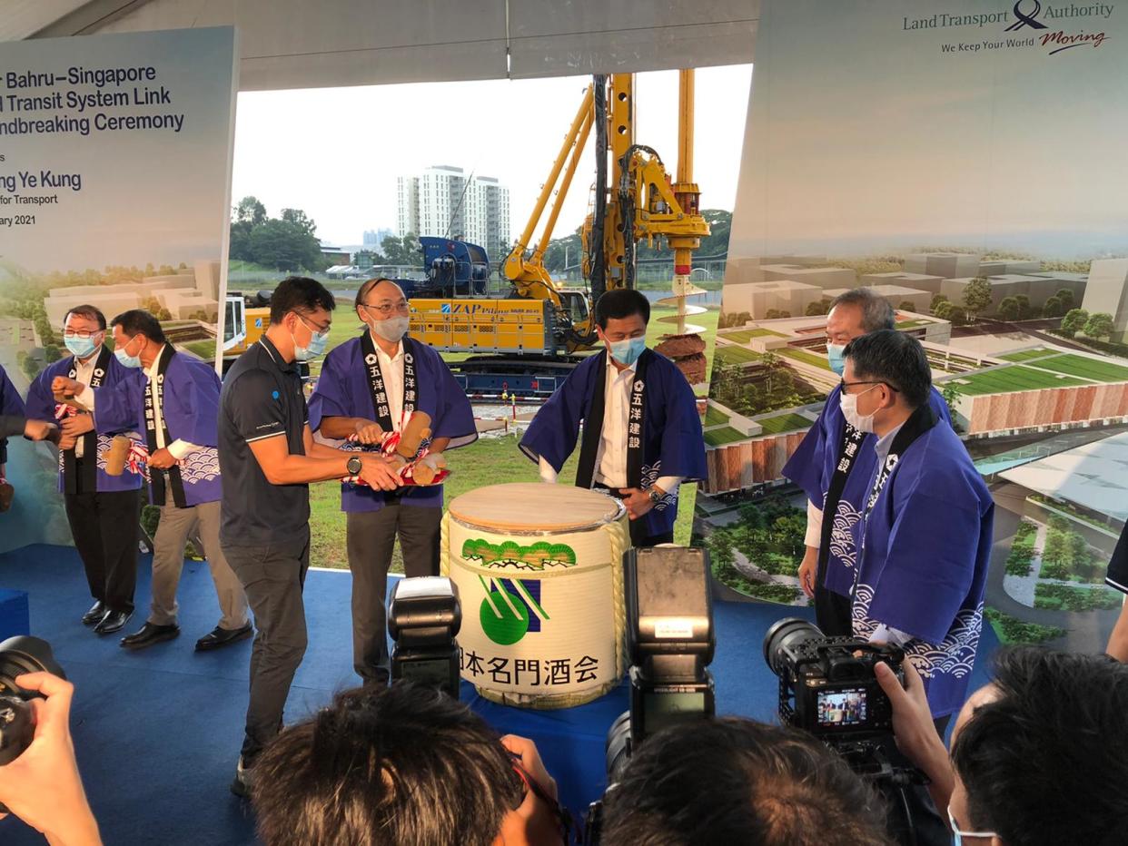 Transport Minister Ong Ye Kung (middle) takes part in a sake barrel breaking ceremony for good luck, at the groundbreaking for the RTS Link Woodlands North Station on Friday, 22 January. The station will be constructed by Penta-Ocean Construction, a Japanese firm. (PHOTO: Nicholas Yong/Yahoo News Singapore)