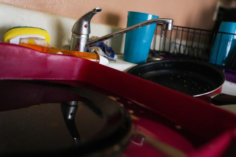 Water drips from a leaky faucet at Pam Wiedman's home in Mesa.