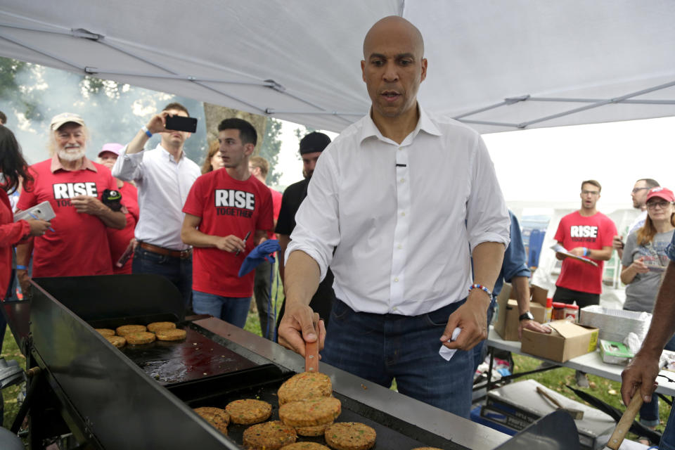 Democratic presidential candidate Sen. Cory Booker, D-N.J. flips veggie burgers at the Polk County Democrats Steak Fry, in Des Moines, Iowa, Saturday, Sept. 21, 2019. (AP Photo/Nati Harnik)