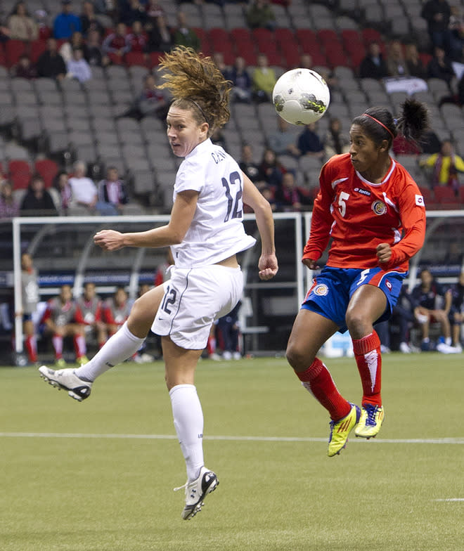 VANCOUVER, CANADA - JANUARY 27: Lauren Cheney #12 of the United States out jumps Diana Saenz #5 of Costa Rica for the loose ball during the first half of semifinals action of the 2012 CONCACAF Women's Olympic Qualifying Tournament at BC Place on January 27, 2012 in Vancouver, British Columbia, Canada. (Photo by Rich Lam/Getty Images)