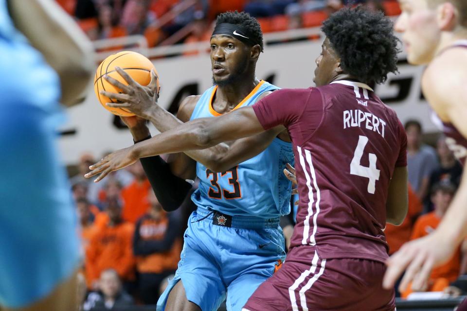 Oklahoma State forward Moussa Cisse (33) passes the ball in the second half during a college basketball game between the Oklahoma State Cowboys (OSU) and the Southern Illinois Salukis at Gallagher-Iba Arena in Stillwater, Okla., Thursday, Nov. 10, 2022.