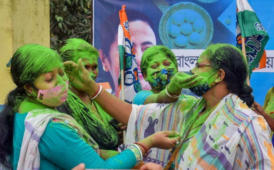 Women in Nadia district on Wednesday smear gulaal on each other after TMC supremo Mamata Banerjee took oath as the Chief Minister of West Bengal for the third time.