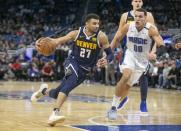 Dec 5, 2018; Orlando, FL, USA; Denver Nuggets guard Jamal Murray (27) drives past Orlando Magic forward Aaron Gordon (00) during the second half at Amway Center. Reinhold Matay-USA TODAY Sports