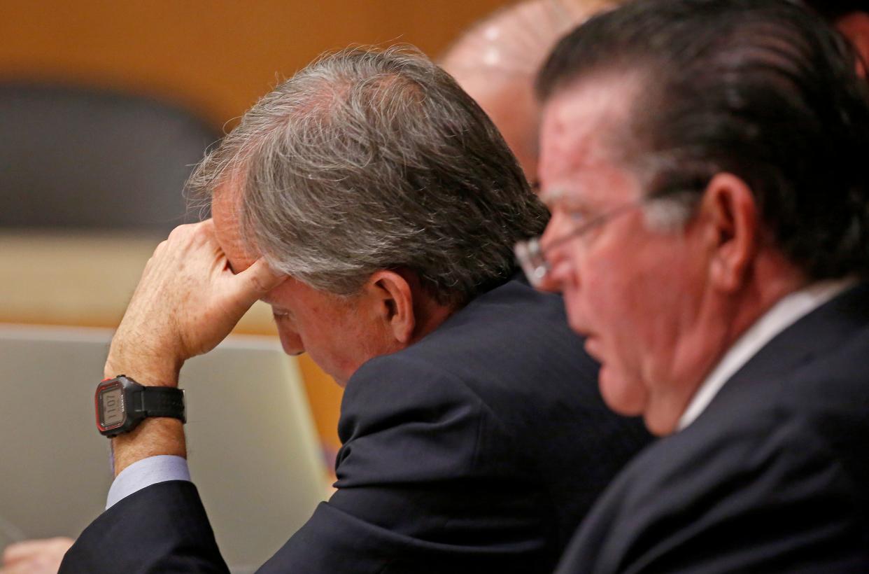 Texas Attorney General Ken Paxton (left) looks at his note next to his attorney Dan Cogdell during his pretrial hearing at Collin County Courthouse in McKinney, Texas, Thursday, Feb. 16, 2017.