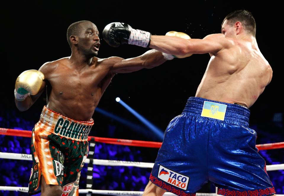 Terence Crawford throws a punch at Viktor Postol. (Getty Images)