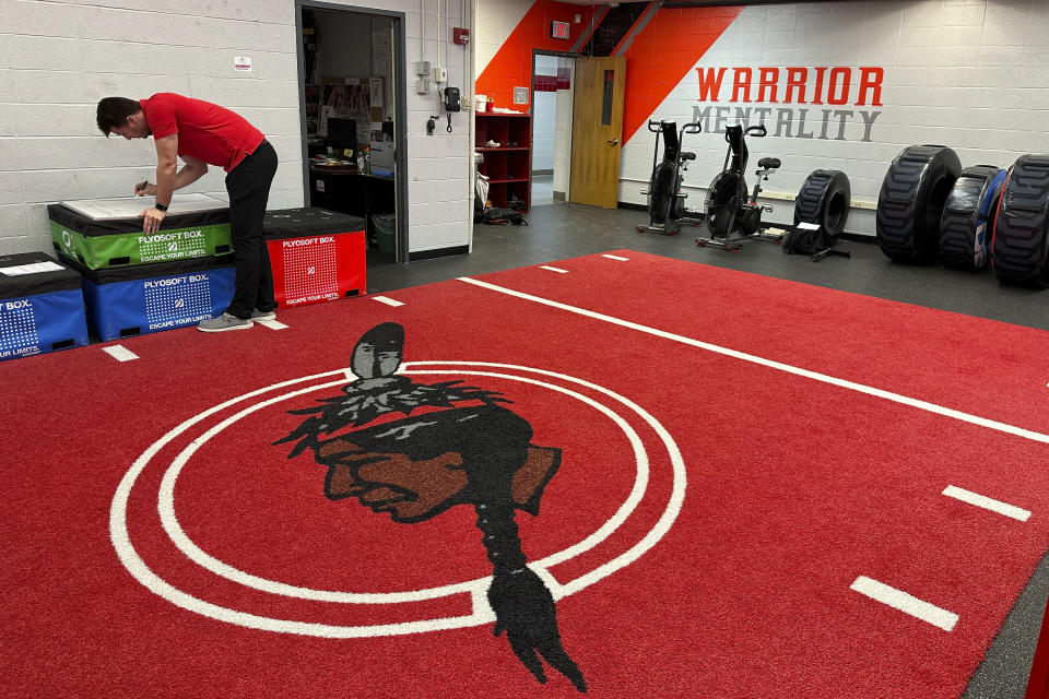 The logo of the Salamanca City Central School District is dyed into the weight room carpet at Salamanca High School in Salamanca, N.Y., on April 18, 2023. The school district, located on Seneca Nation of Indians territory, may have to replace its logo after New York passed a ban on the use of Indigenous names, mascots and logos by public schools. (AP Photo/Carolyn Thompson)