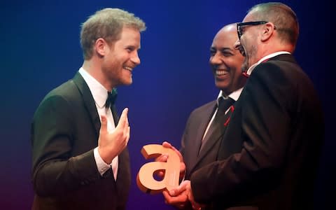 Prince Harry receives a posthumous Attitude Legacy Award on behalf of his mother Diana, Princess of Wales, from Ian Walker and Julian La Bastide at the Attitude Awards in London - Credit: Reuters