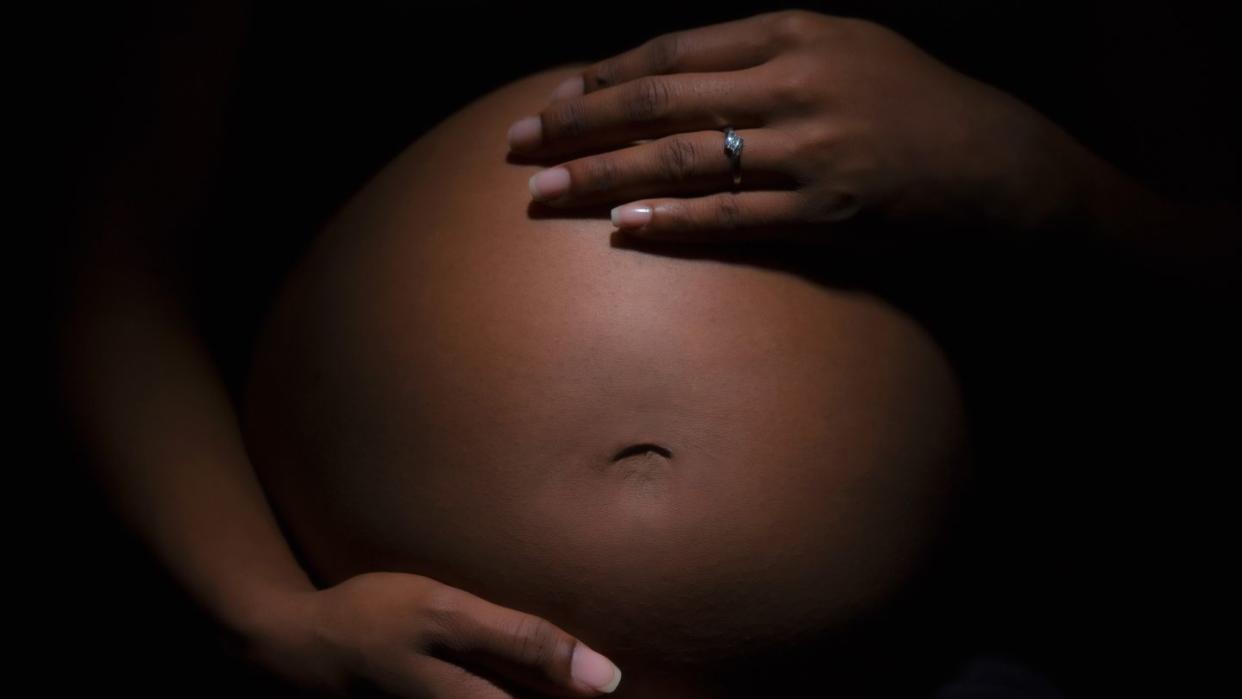 a person holding a baby's stomach