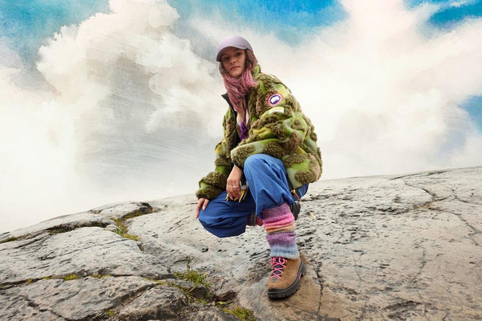 a girl sitting on a rock