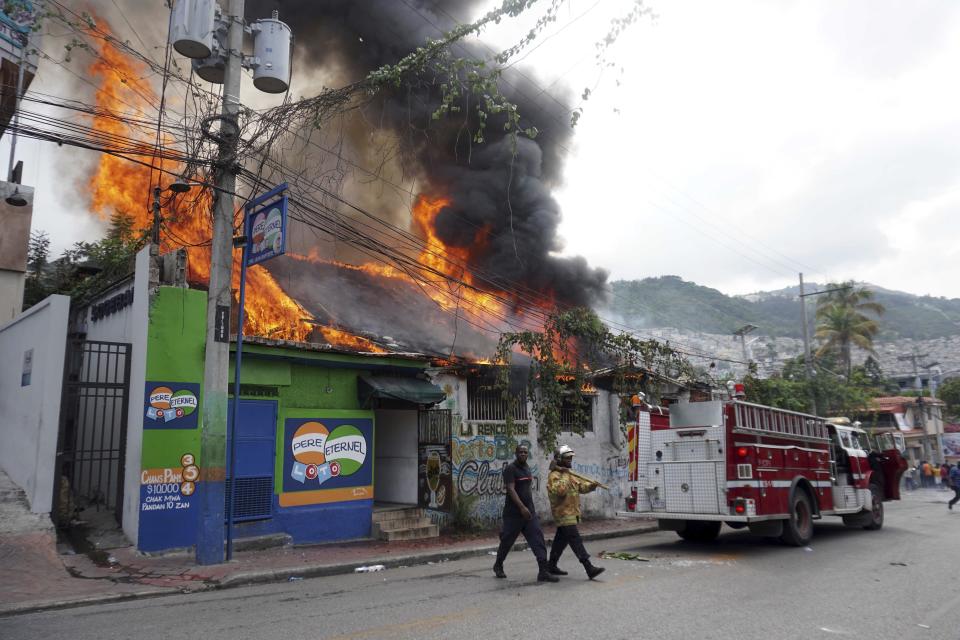 The roof of a building burns, set on fire by protesters in Port-au-Prince, Haiti, Friday, Sept. 27, 2019. Thousands of protesters seeking to oust President Jovenel Moise attacked businesses and government buildings across Haiti Friday, creating chaos on the streets after a weeks-long shutdown of vital services that has damaged the country’s ailing economy and shaken the president’s already tenuous position. (AP Photo/Edris Fortune)