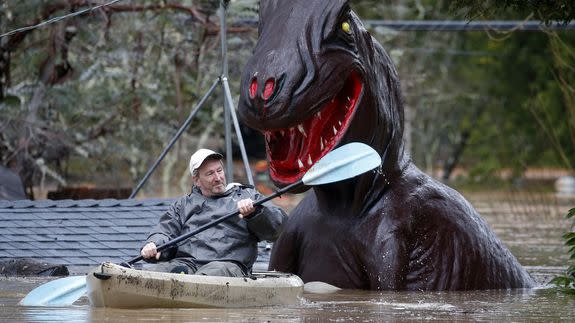 Rich Willson paddles through the miniature golf course after the flooding in in Guerneville, California.