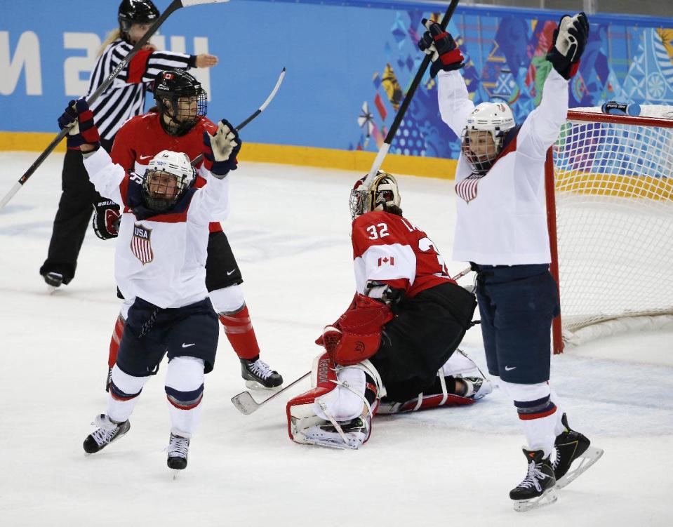 Hilary Knight, right, and Kelli Stack, left, of the United States celebrate Knight's goal against Goalkeeper Charline Labonte of Canada during the second period of the 2014 Winter Olympics women's ice hockey game at Shayba Arena, Wednesday, Feb. 12, 2014, in Sochi, Russia. (AP Photo/Petr David Josek)