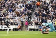 Newcastle United's Anthony Gordon, left, scores their side's second goal during the English Premier League soccer match between Newcastle United and Tottenham Hotspur at St. James' Park in Newcastle, England, Saturday, April 13, 2024. (Owen Humphreys/PA via AP)