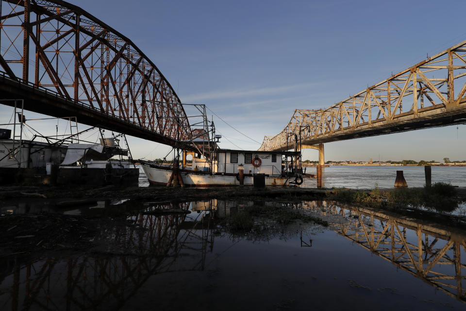 Fishing vessels are seen docked in Morgan City, La. Monday, May 11, 2020. Attempts to curb the spread of COVID-19 have visited a kind of triple economic whammy on the state. As oil prices have plummeted, the industry laid off workers. Tourism has dried up, meaning more lost jobs. And one major tourist draw — cuisine built around fin fish, shrimp, oyster and crabs — is also suffering. (AP Photo/Gerald Herbert)