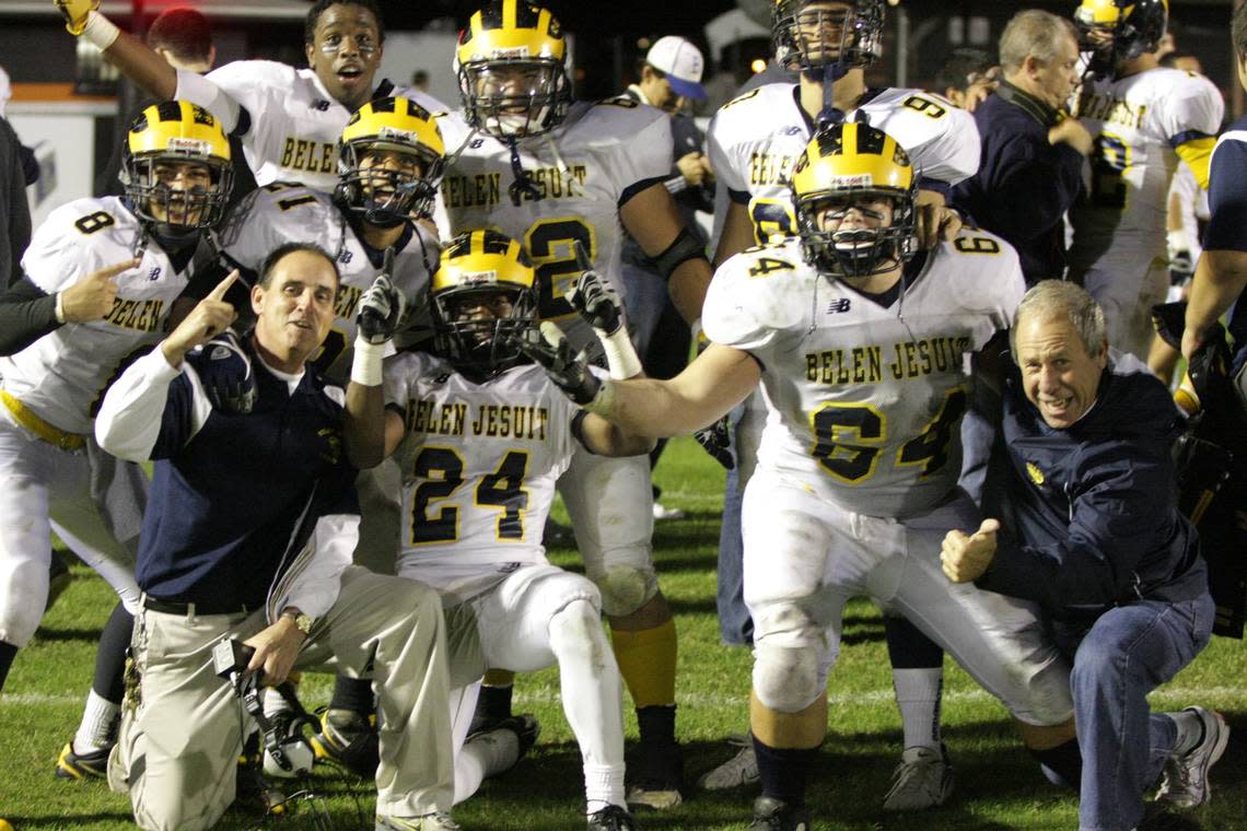 Belen athletic director Carlos Barquin (right) celebrates with players from the Wolverines’ football team that made the school’s lone trip to the state finals in 2009.
