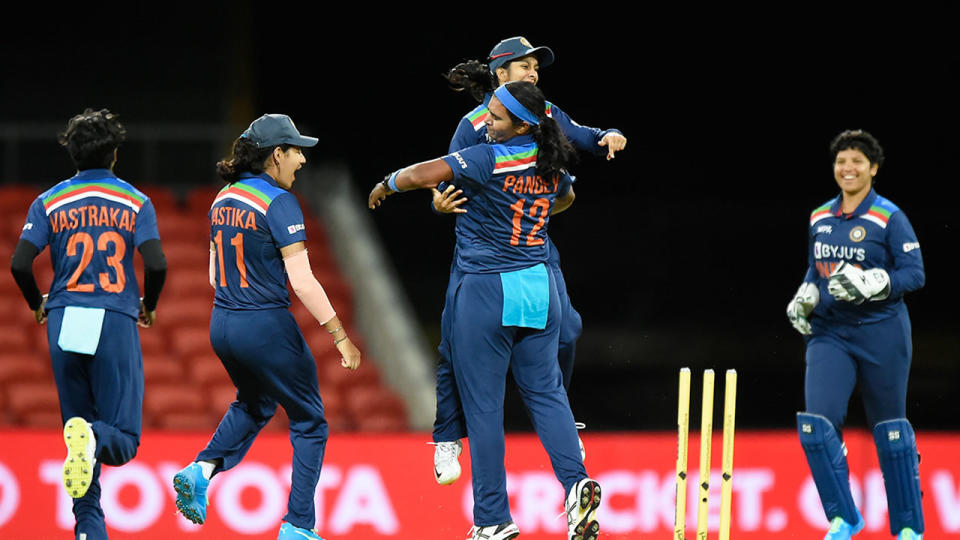 Seen here, Shikha Pandey celebrates with Indian teammates after taking the wicket of Alyssa Healy. 