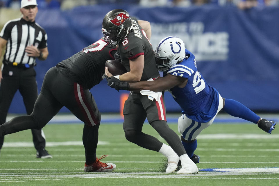 Indianapolis Colts defensive end Tyquan Lewis (94) sacks Tampa Bay Buccaneers quarterback Baker Mayfield (6) during the second half of an NFL football game Sunday, Nov. 26, 2023, in Indianapolis. (AP Photo/Michael Conroy)