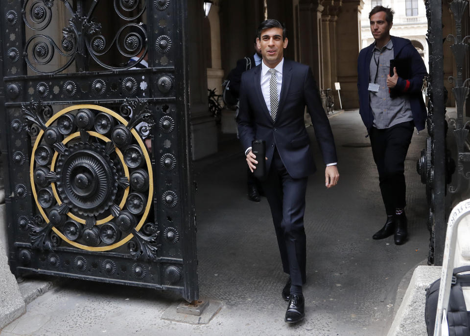 Britain's Chancellor of the Exchequer Rishi Sunak walks to Downing Street in London, Wednesday, May 13, 2020. The British economy shrank 2% in the first quarter of the year from the previous three-month period, the biggest quarterly decline since the global financial crisis of 2008 even though it included just one week of the coronavirus lockdown, official figures showed Wednesday. (AP Photo/Frank Augstein)