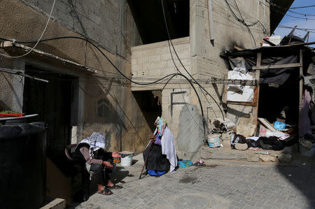 Grandparents of Palestinian boy Mohammad An-Najjar, 12, who was wounded in his eye during a protest at the Israel-Gaza border fence, sit outside their house, in Khan Younis, in the southern Gaza Strip, January 21, 2019. REUTERS/Ibraheem Abu Mustafa