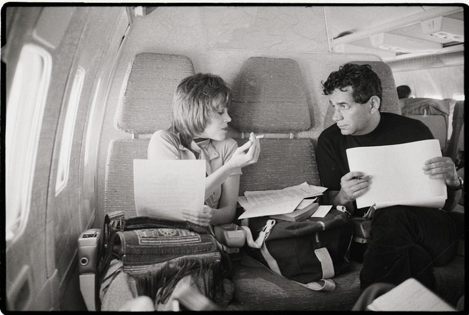 <p>Jane Fonda and author Mark Lane share notes during a flight en route from Los Angeles to San Francisco in 1970.</p>