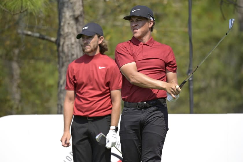 Tommy Fleetwood, left, of England, and Cameron Champ watch his tee shot on the 11th hole during the final round of the Workday Championship golf tournament Sunday, Feb. 28, 2021, in Bradenton, Fla. Both are wearing clothing honoring Tiger Woods. (AP Photo/Phelan M. Ebenhack)