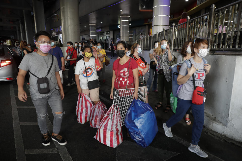 Commuters wearing face masks to help prevent the spread of the coronavirus wait for rides in Quezon City, Philippines on Monday, May 24, 2021. The Philippines, a coronavirus hotspot in Southeast Asia, has received more than eight million doses of COVID-19 vaccine since February, but less than half have been administered so far, said officials, adding that among the problems were public hesitancy and low registration for the jabs. (AP Photo/Aaron Favila)