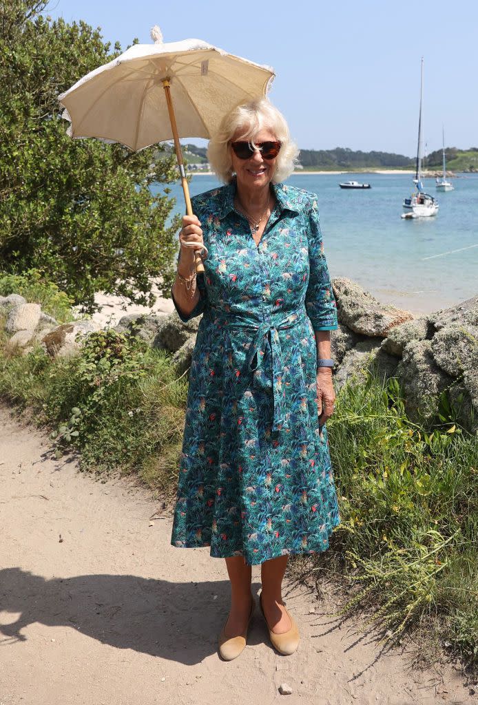<p>Camilla looked ready for summer vacation on a recent trip to the Isles of Scilly off the coast of Cornwall. Spot the toucans on her tropical printed dress! </p>