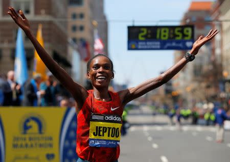 Kenya's Rita Jeptoo reacts after winning the women's division at the 118th running of the Boston Marathon in Boston, Massachusetts April 21, 2014. REUTERS/Brian Snyder