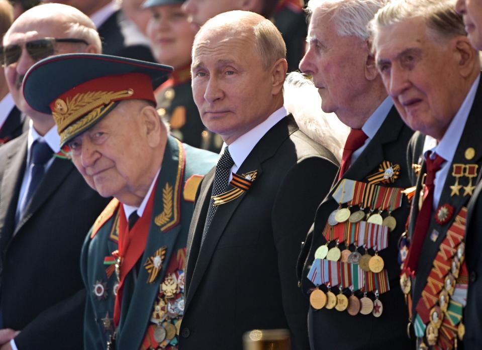 FILE - In this June 24, 2020, file photo, Russian President Vladimir Putin, center, watches the Victory Day military parade marking the 75th anniversary of the Nazi defeat in Moscow. Putin is just a step away from bringing about the constitutional changes that would allow him to extend his rule until 2036. The vote that would reset the clock on Putin’s tenure in office and allow him to serve two more six-year terms is set to wrap up Wednesday, July 1, 2020. (Sergei Guneyev/Host Photo Agency via AP, File)