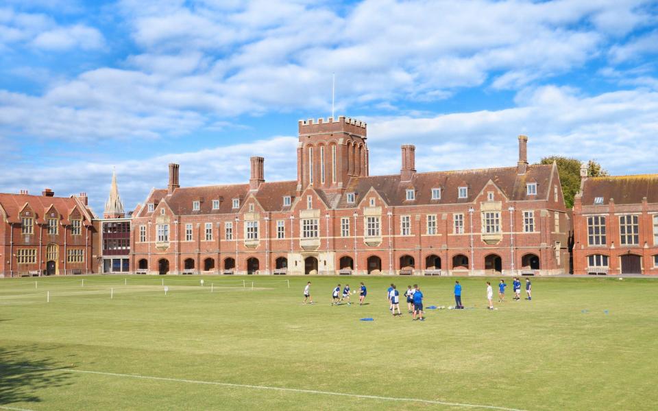 Students practicing rugby in the sports field at Eastbourne College - ALAMY