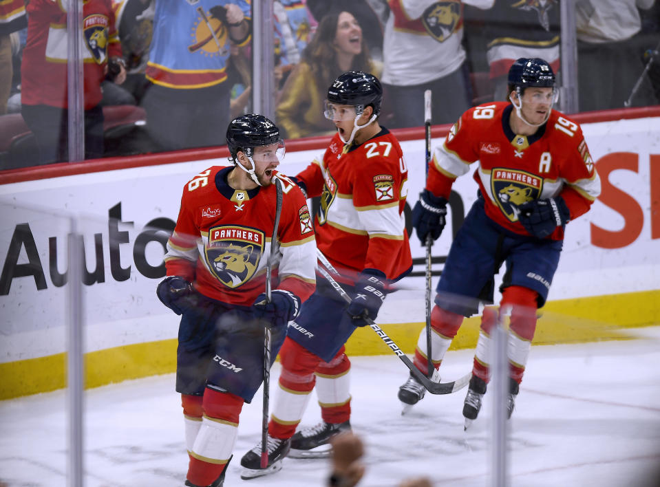 Florida Panthers defenseman Uvis Balinskis (26) celebrates his first NHL goal, during the first period of the team's hockey game against the Carolina Hurricanes, Friday, Nov. 10, 2023, in Sunrise, Fla. (AP Photo/Michael Laughlin)